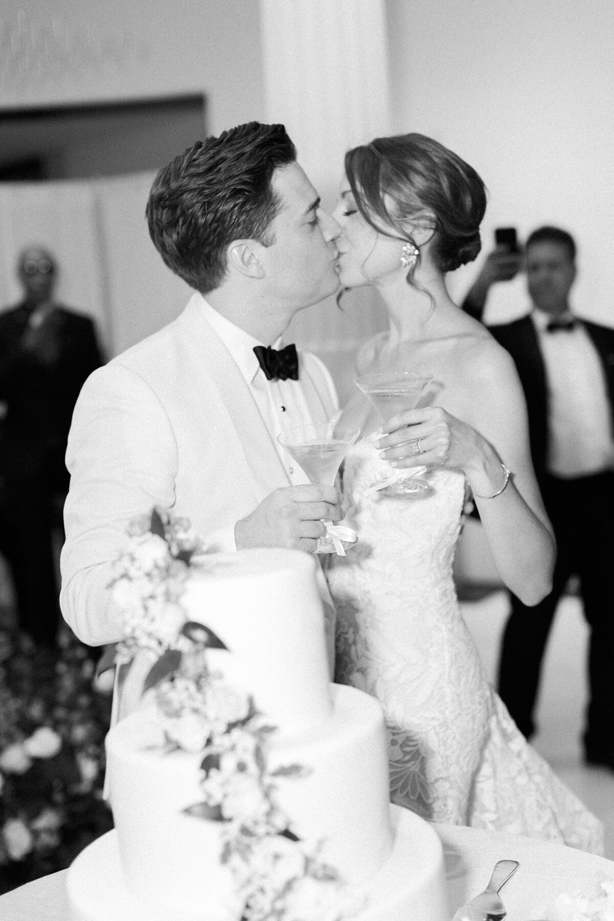 bride and groom kissing at reception by nicole detone photography