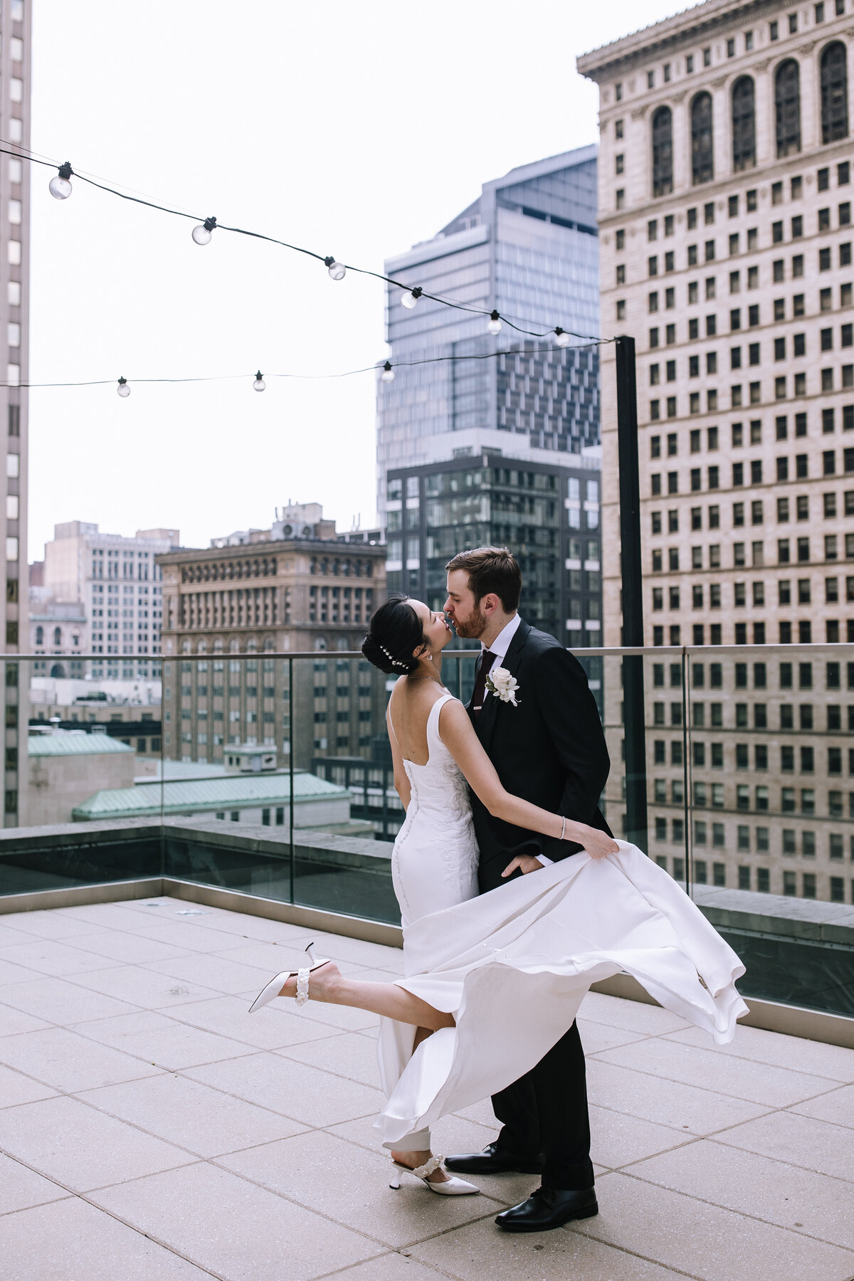 Bride and groom kissing on the Kimpton Hotel Monaco Pittsburgh rooftop wedding. 