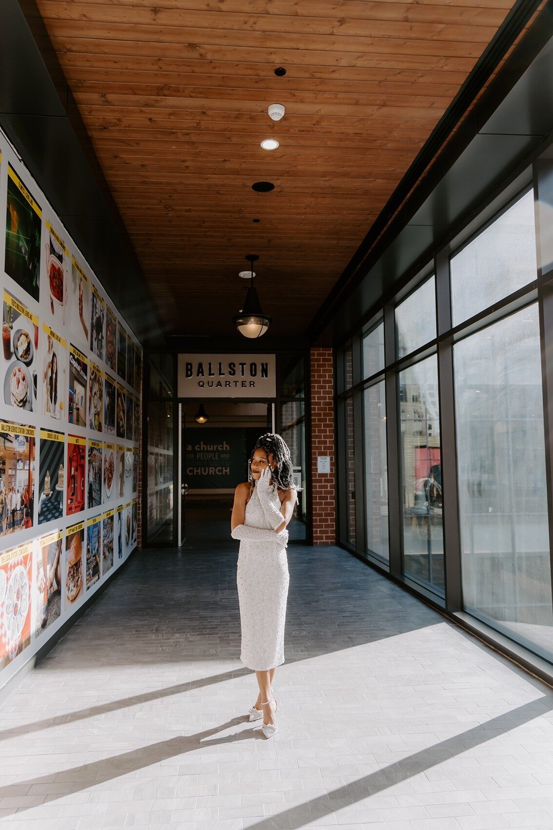 Bride standing on the venue with glass walls