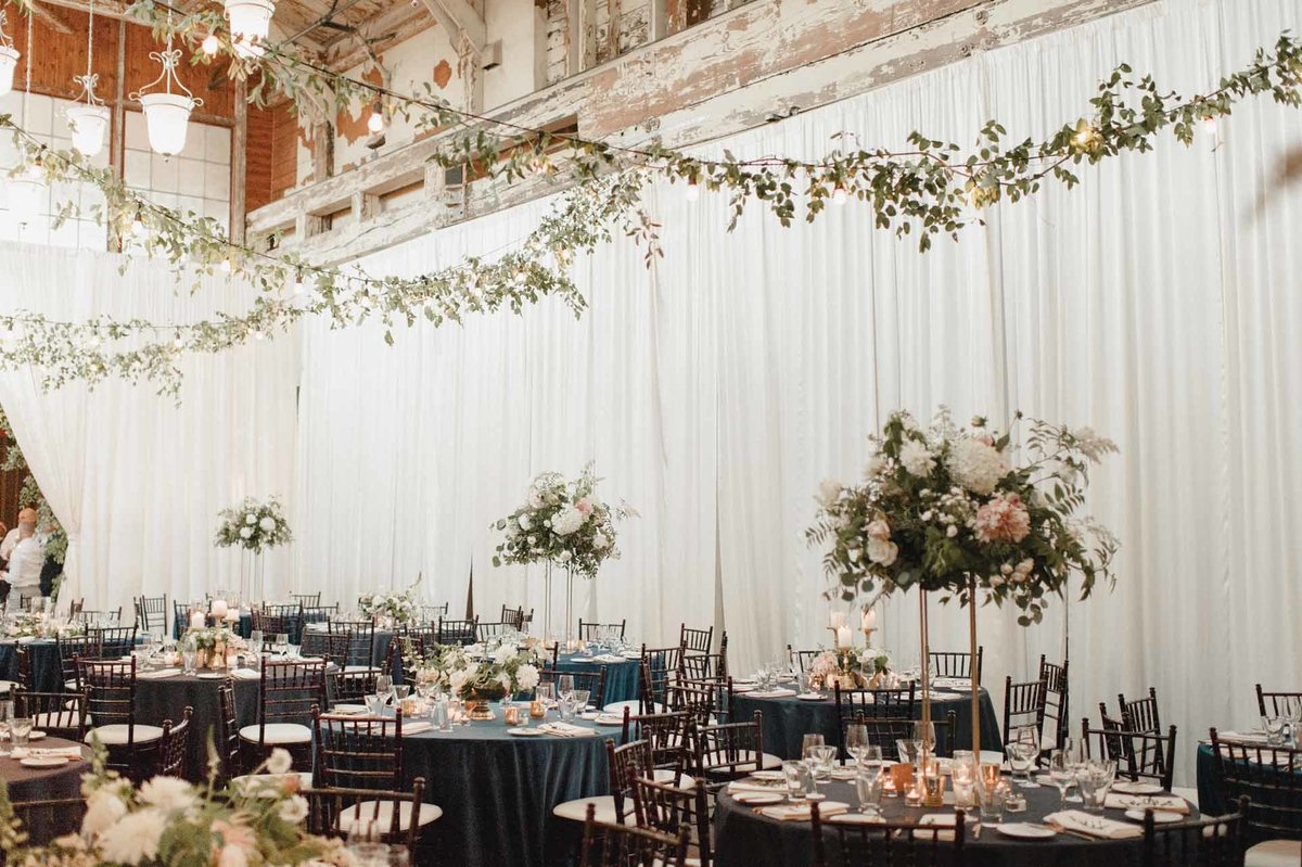 Bright romantic summer wedding with ceiling greens