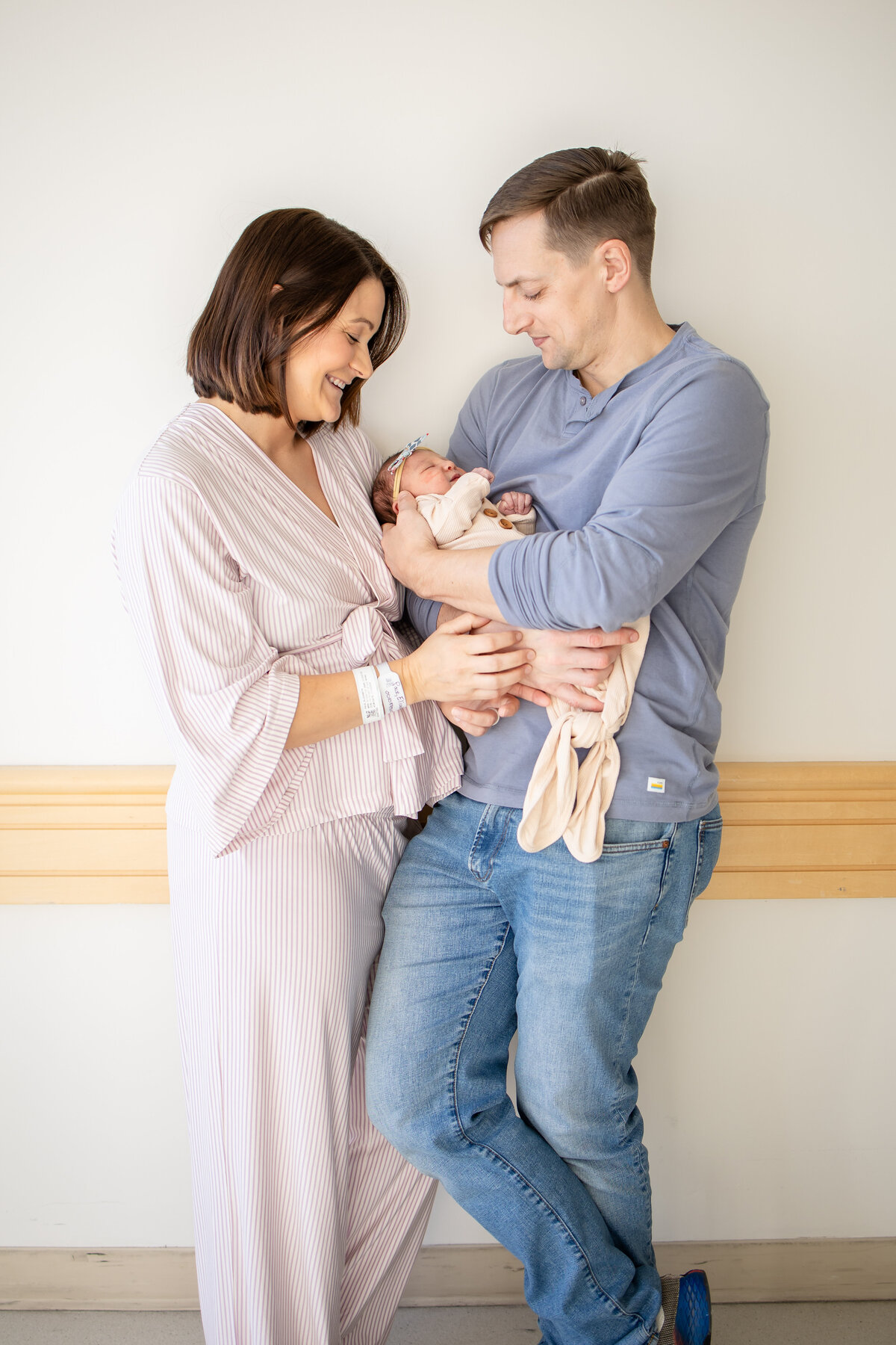 Mom and dad holding newborn baby girl