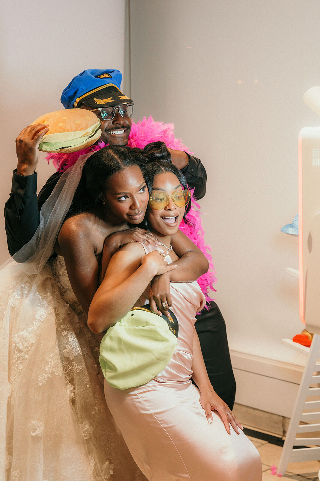 Funny picture of the bride with her friends at the photo booth.