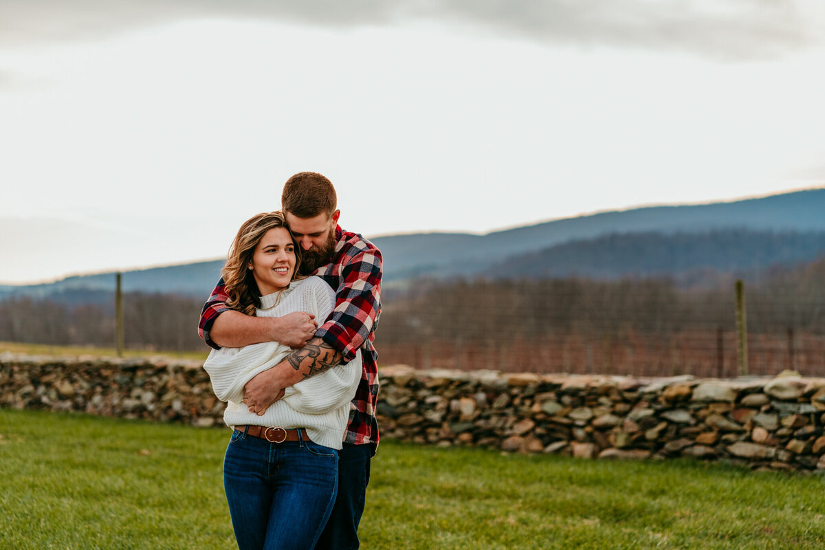 Couple embracing with mountain views behind them