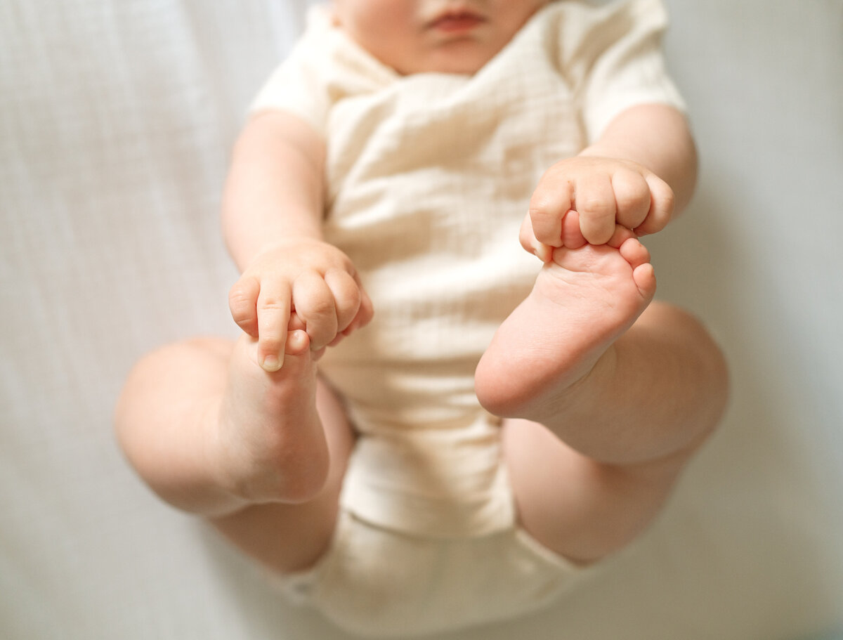 baby holding his toes 