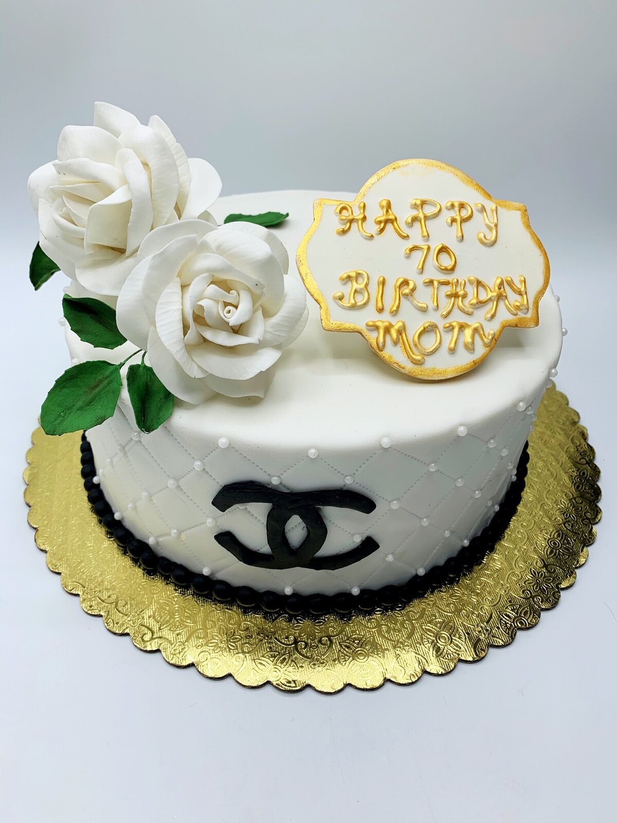 Designer inspired single tier cake with Chanel logo in black and white roses on top