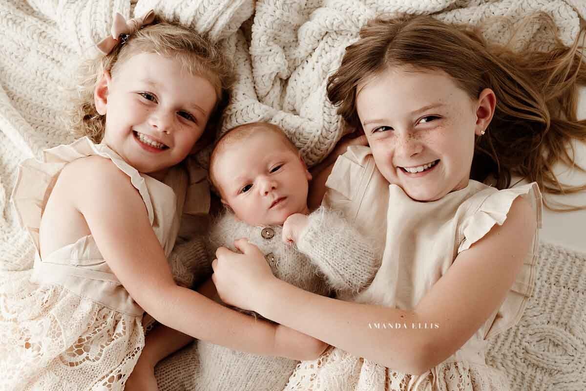 Bright and airy family portrait with newborn