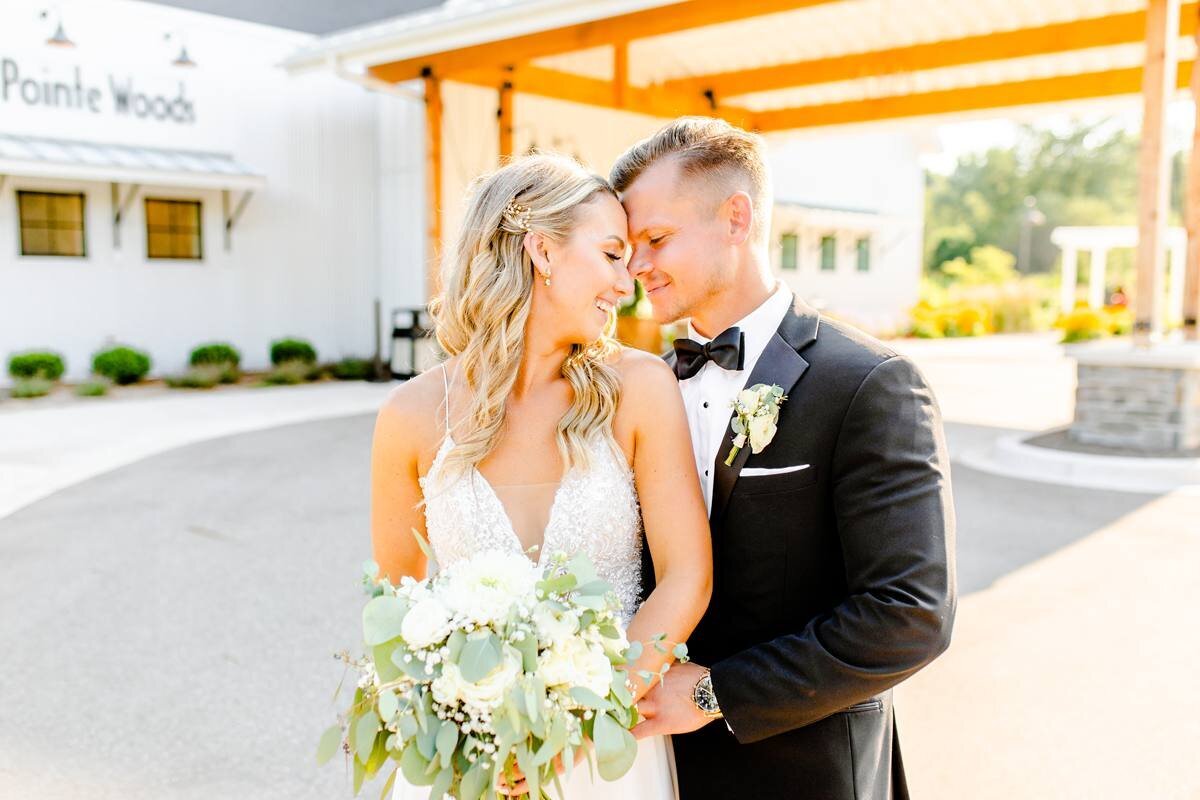 bride and groom rest foreheads together