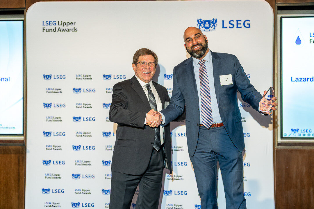 Corporate event photo of business speaker addressing audience from podium during awards event new york.