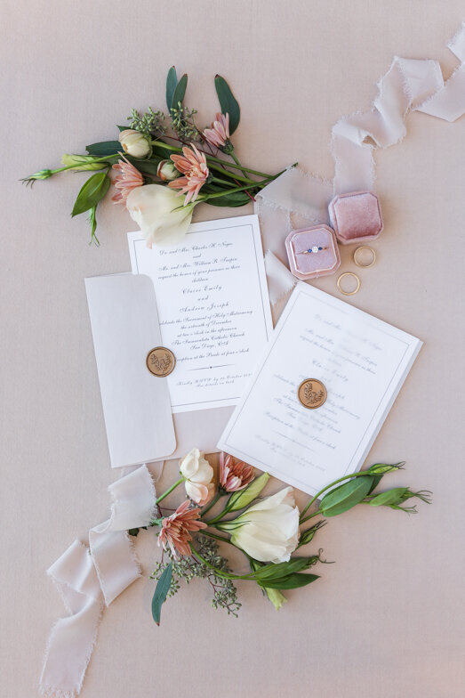wedding invitation flat lay with pink and white flowers