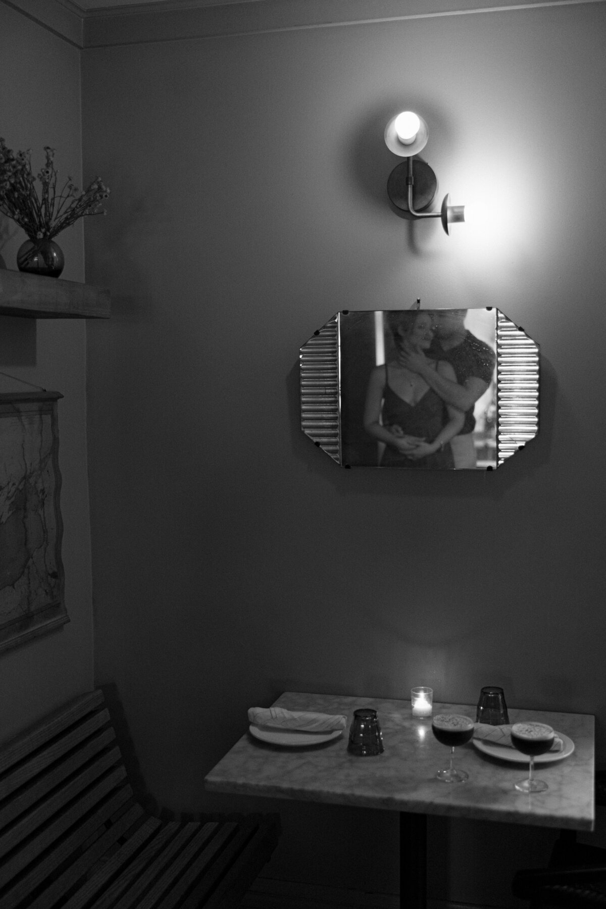Bride and Groom holding each other in the reflection of a vintage mirror at Verns Restaurant  in Rochester, NY