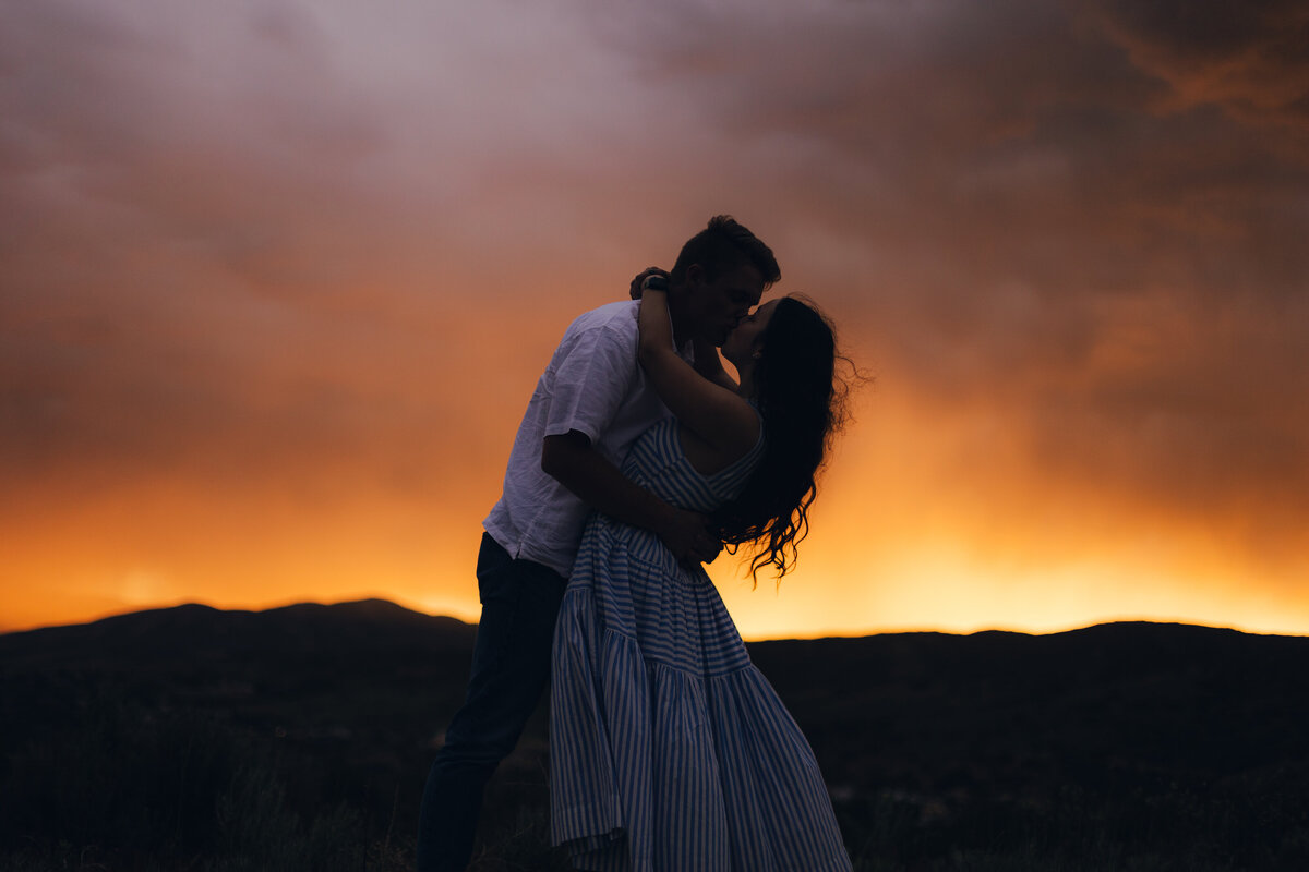 Silhouette of a couple kissing at sunset