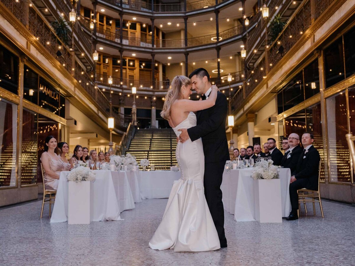 Newlyweds dancing beneath the skylight at The Arcade