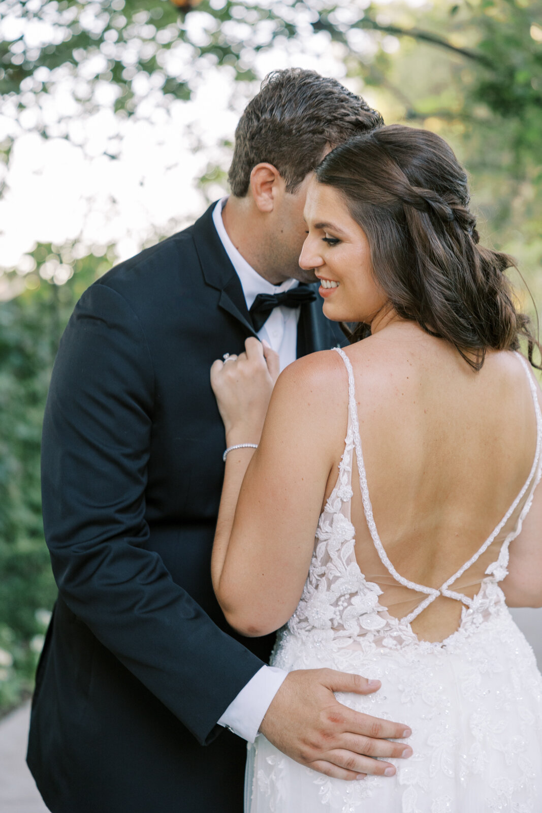 Bride snuggles close to get groom during couples portraits