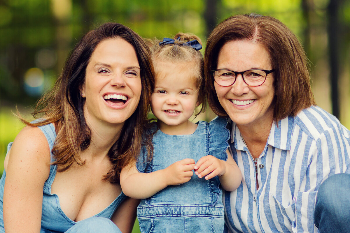 Three generational photo of women - toddler, mom, and grandma, all wearing blue.