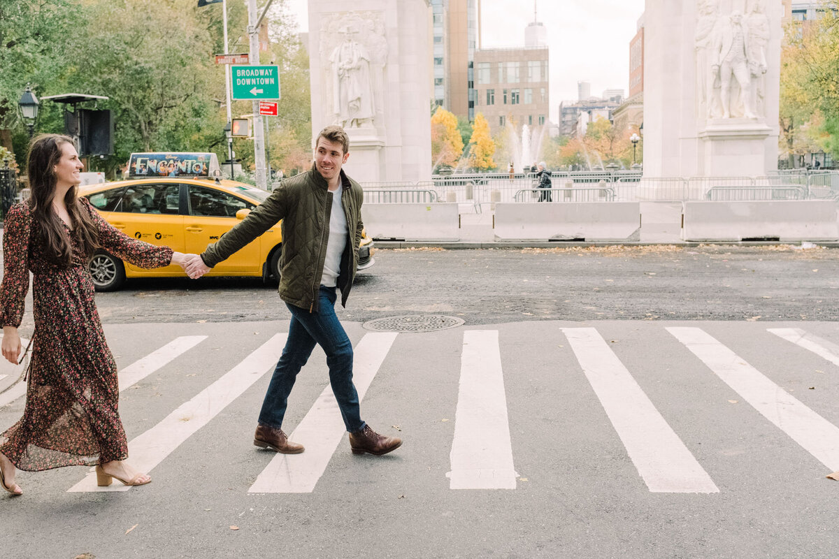 A couple taking a morning stroll through Washington Square Park in the West Village of NYC