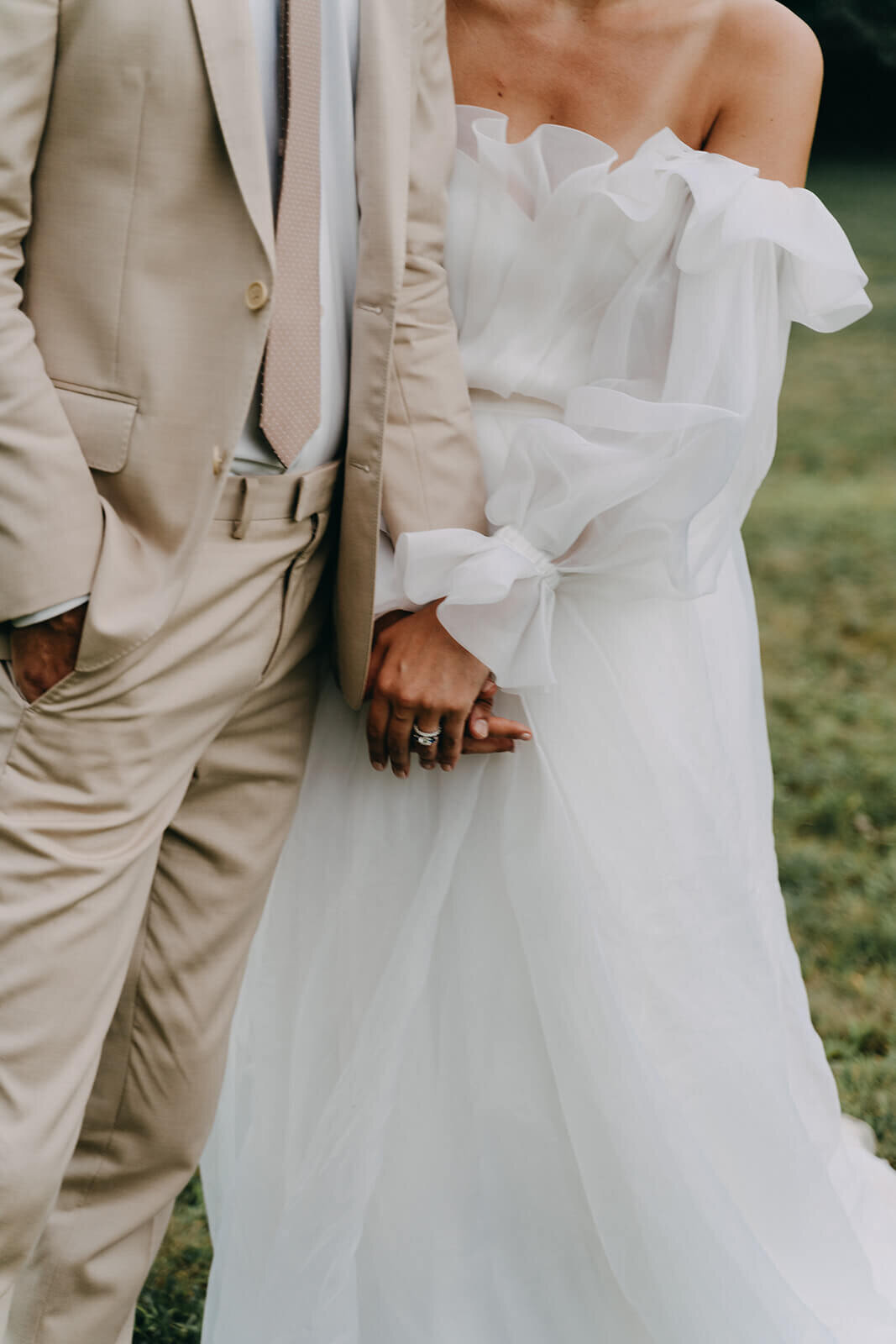 73.closeup-bride-and-groom-holding-hands-wedding-dress-details.