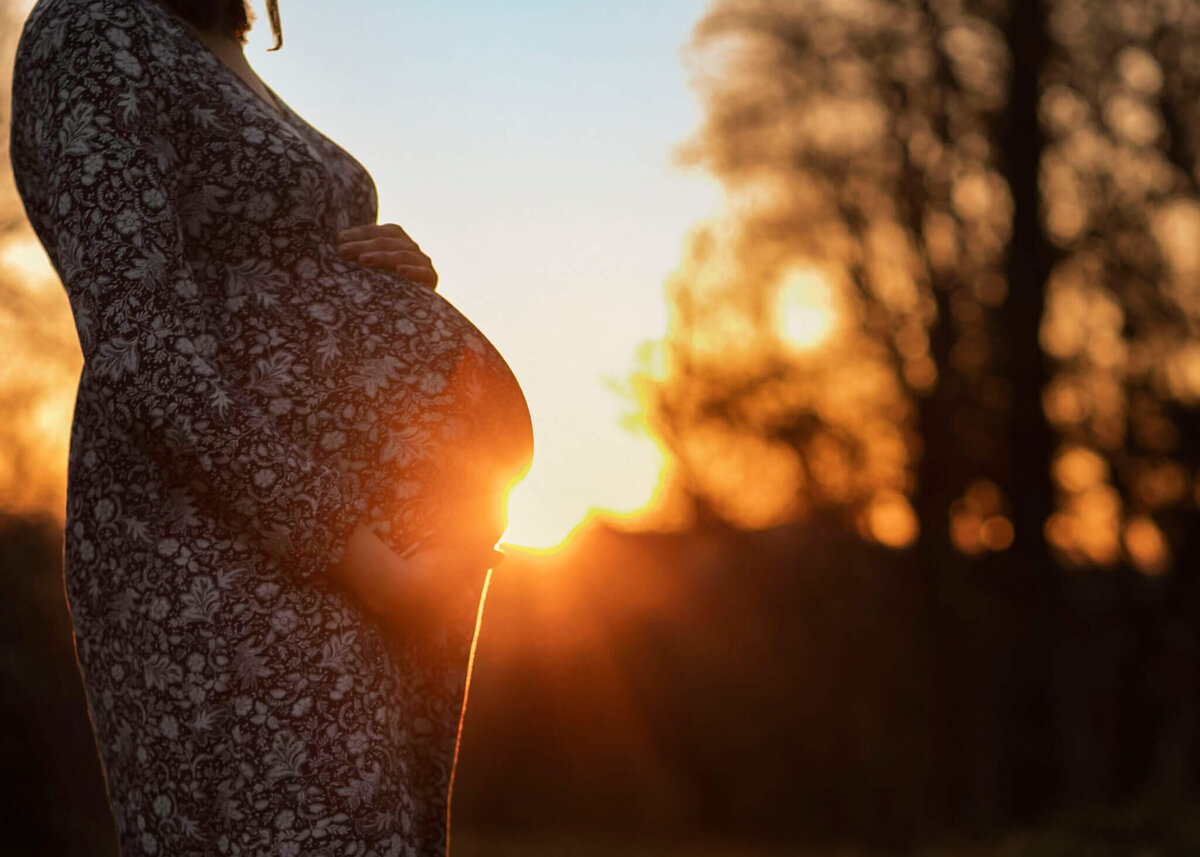 NJ maternity photos of sun shining from mom's belly