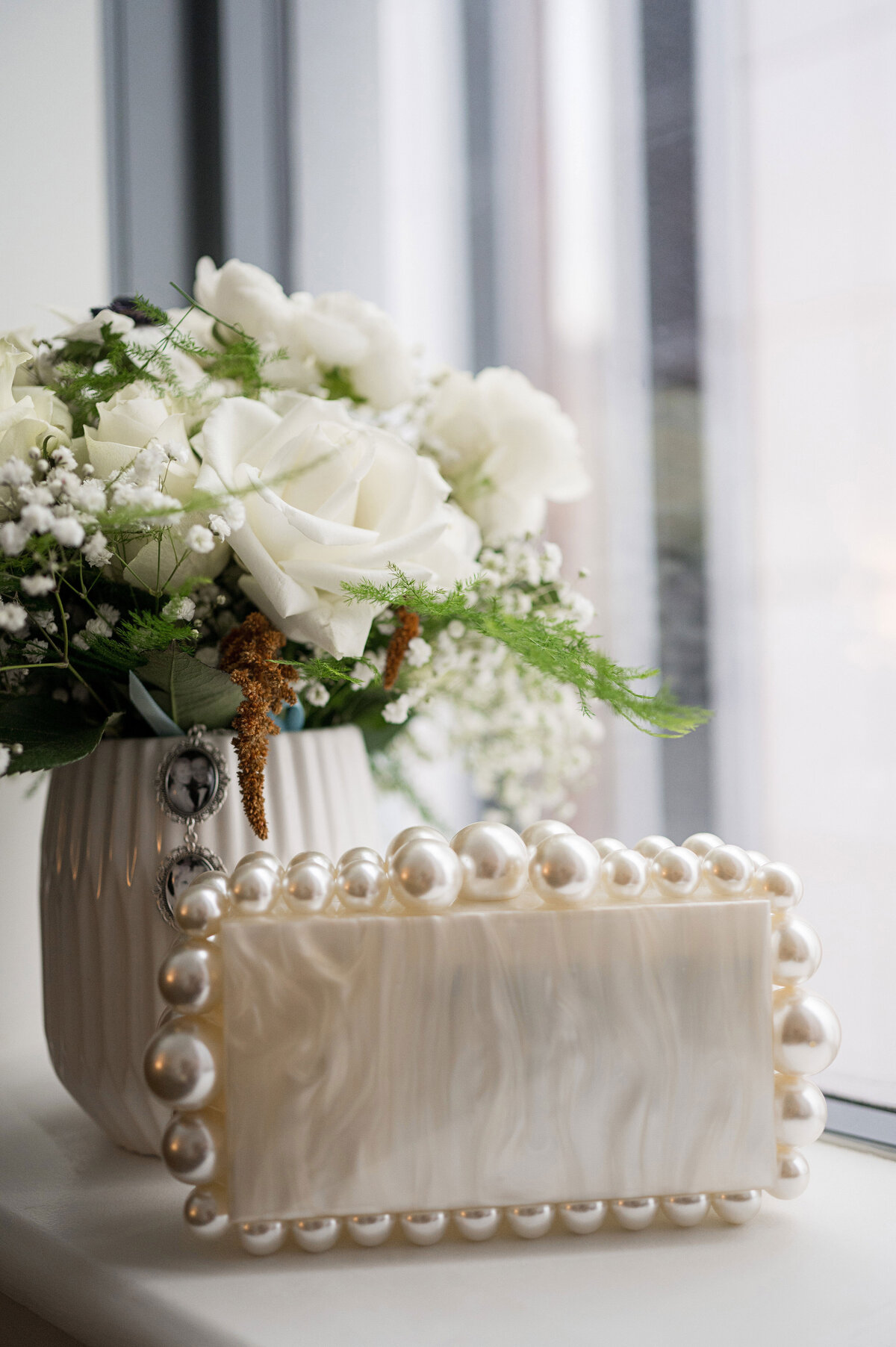 flowers and wedding purse sitting on window sill before wedding day