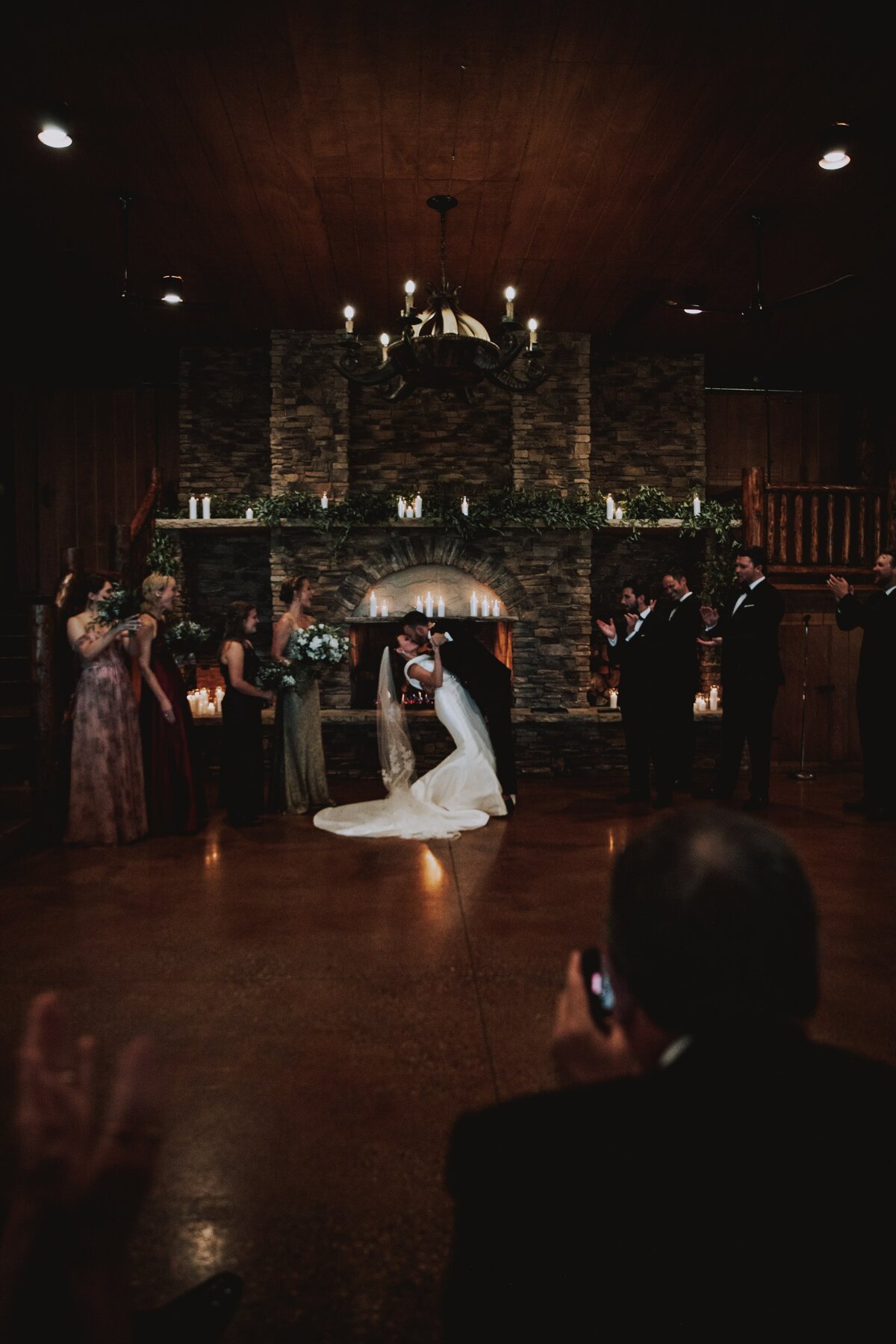 Bride and groom have their first kiss at Spruce Mountain Ranch.