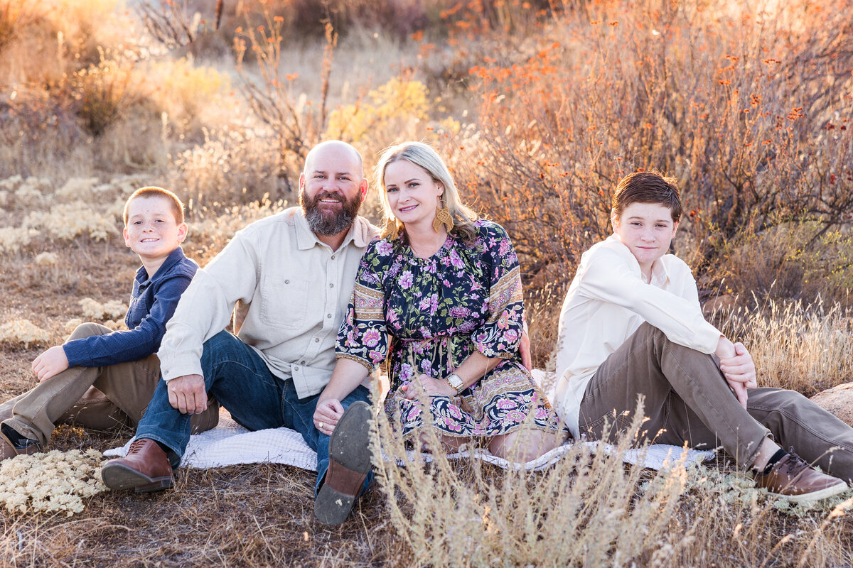 family sitting in wrights field san diego
