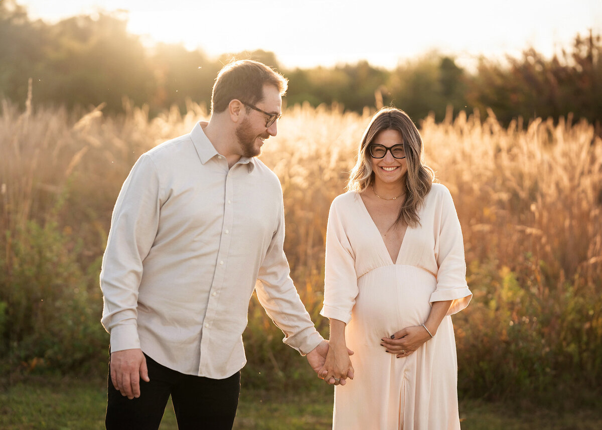 NJ Maternity Photographer captures mom holding herbelly and holding her husband's hand
