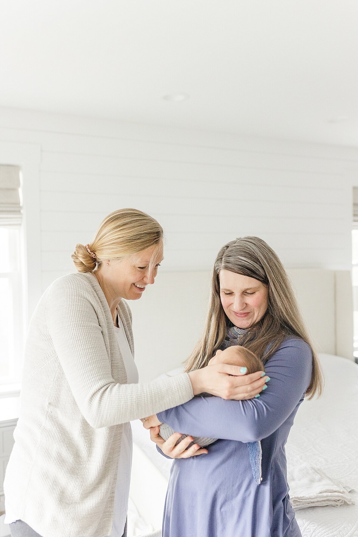 doula holds baby during BURGEONING BUD POST PARTUM DOULA Branding photo session with Sara Sniderman Photography in Natick Massachusetts
