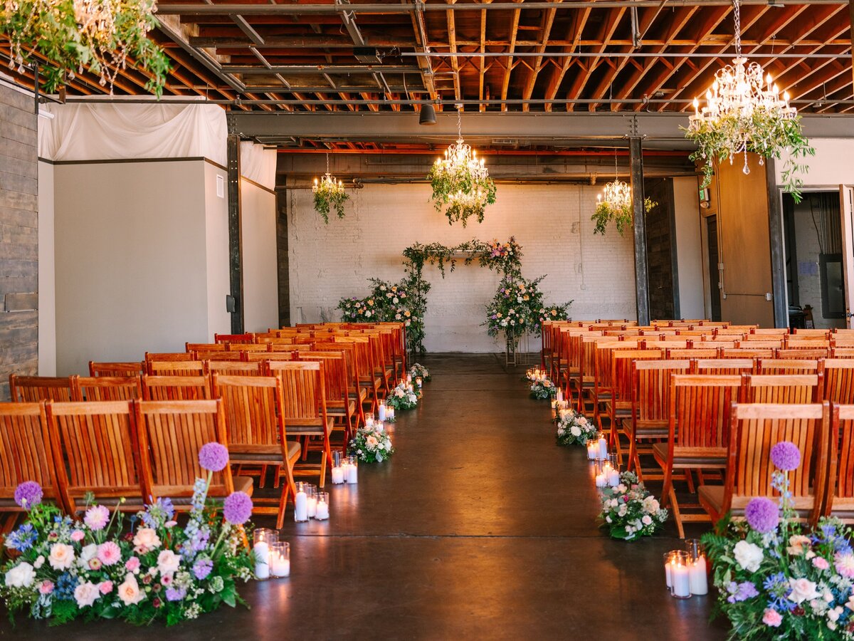 Spring colored floral wedding ceremony setup in the chandelier room of Moss Denver.
