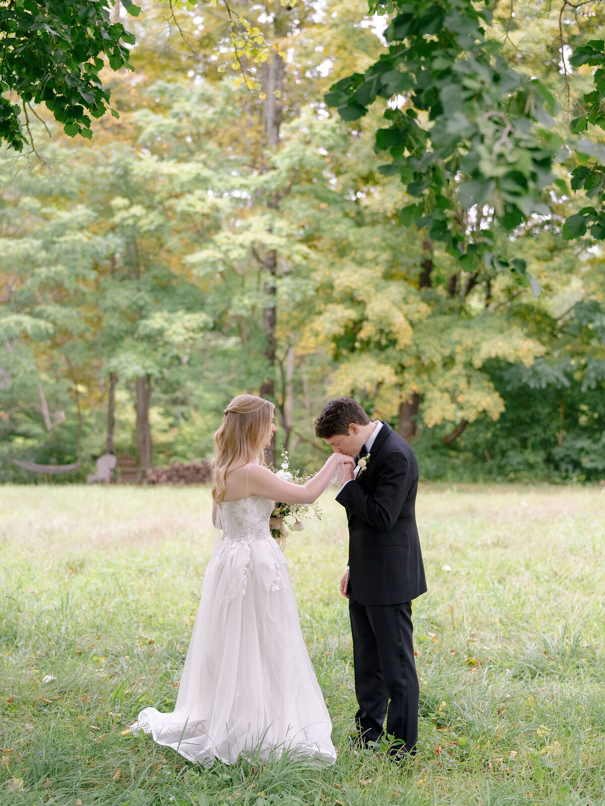 Groom Kissing Brides Hands at Troutbeck