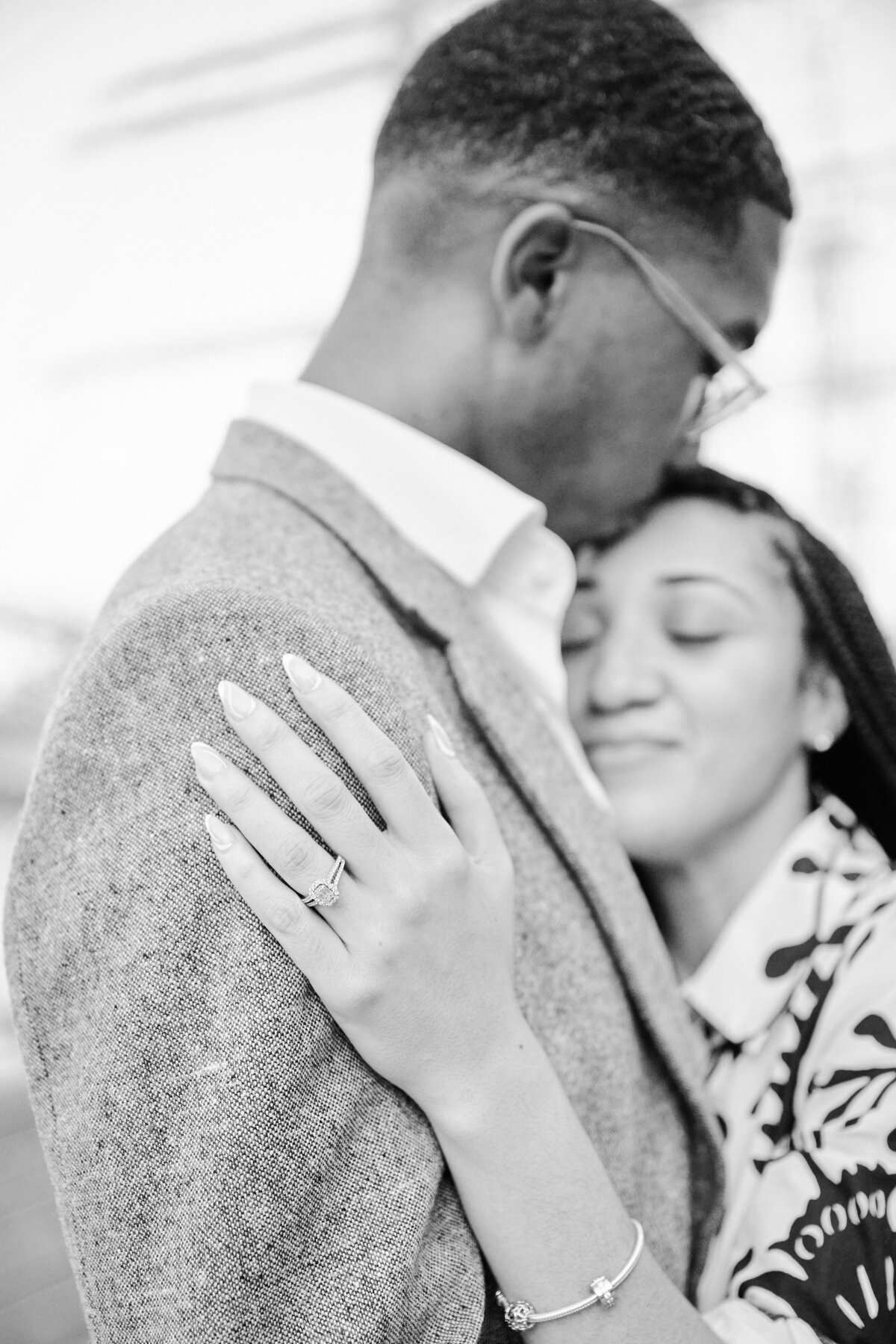 B & W Photo of a couple embracing after a NYC Proposal at The Greens Rooftop,  NYC proposal Photographer, Corey Lamar Photography