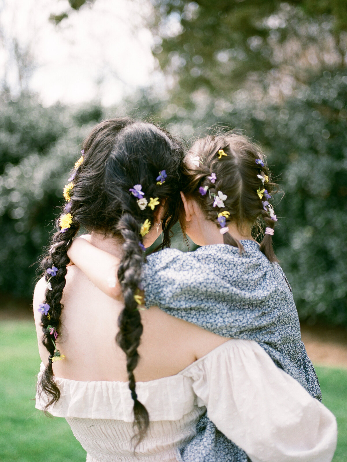 huntsville family photographer documents moment between mother and daughter with flowers in their hair