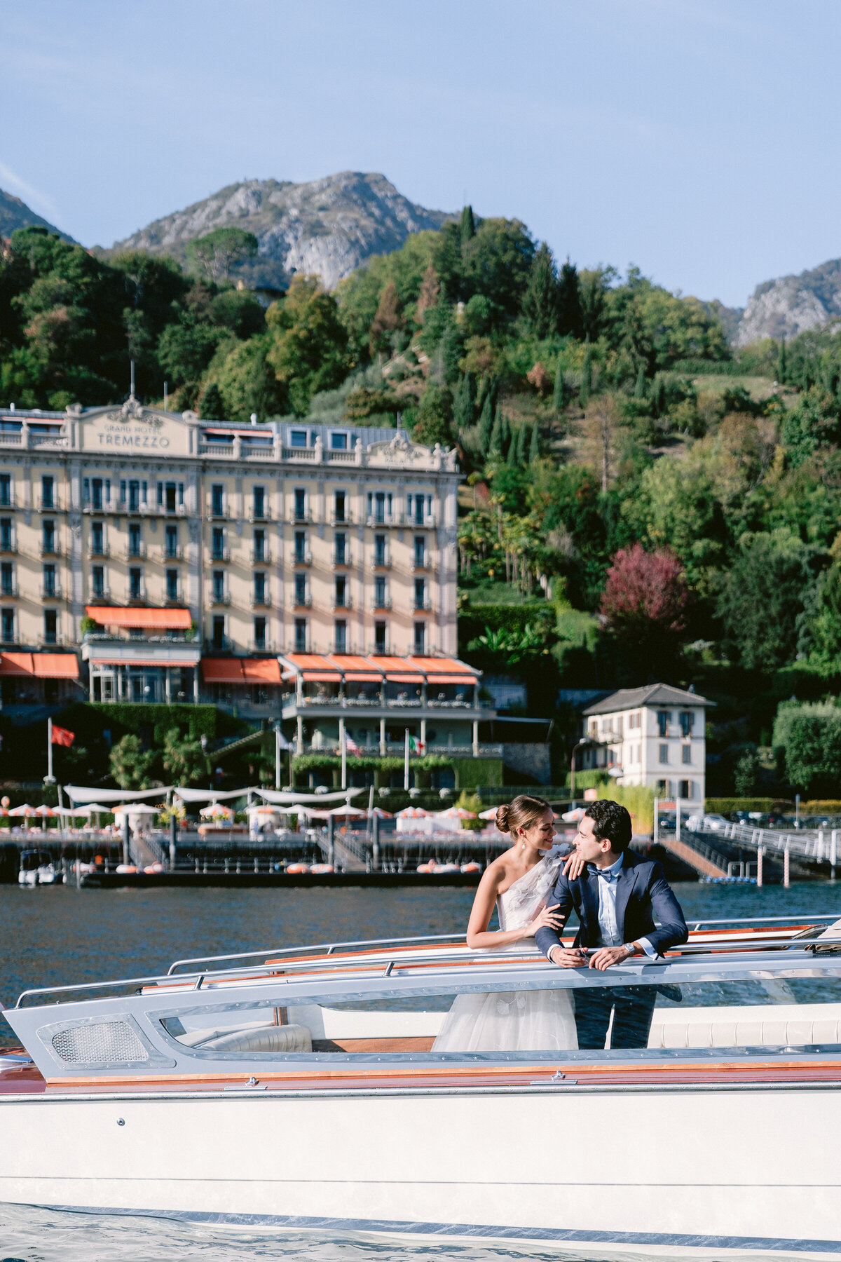 Couple on a private boat on lake como overlooking the Hotel Tremezzo