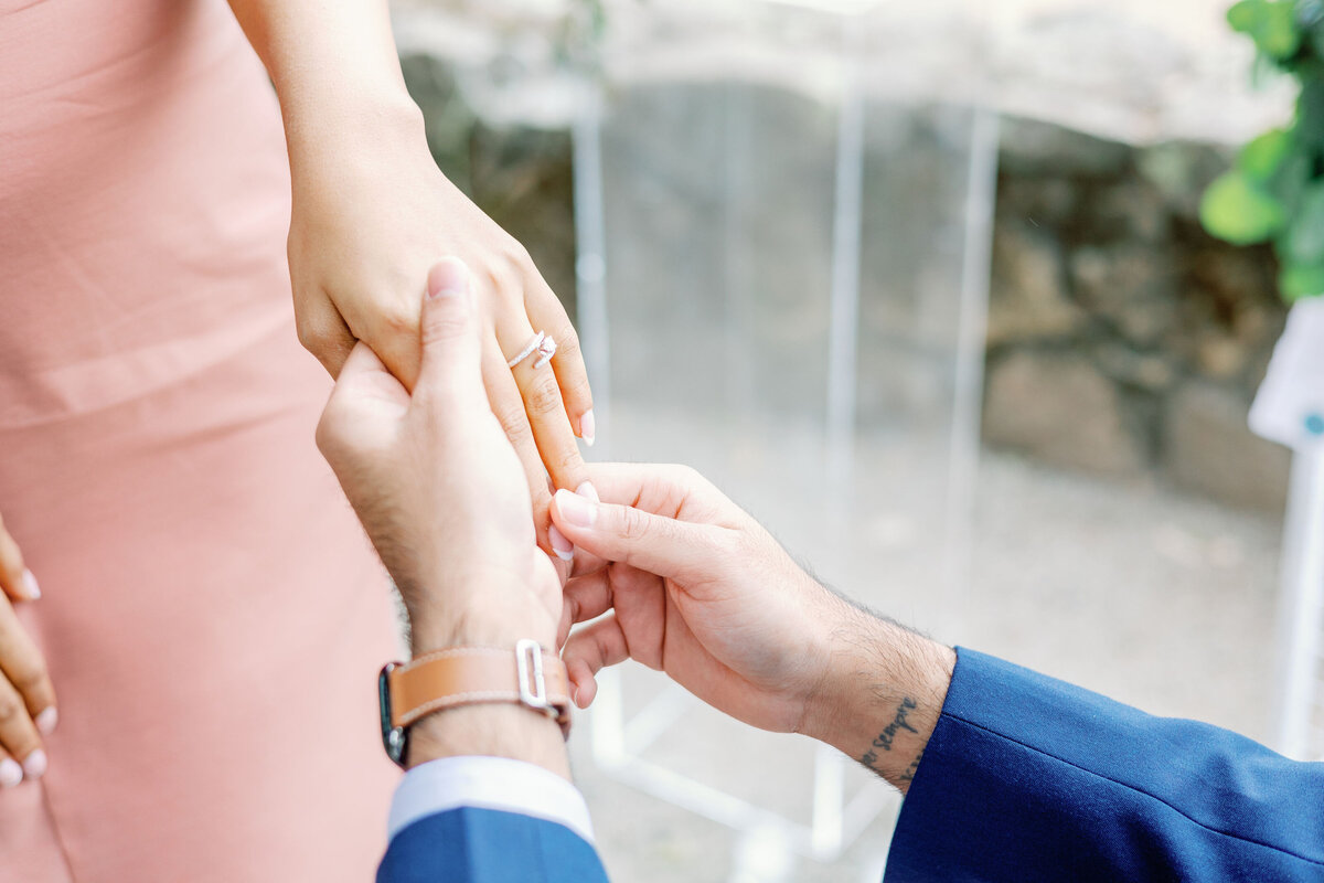 detail shot of man putting on a ring for his surprise proposal pictures by bay area photographers