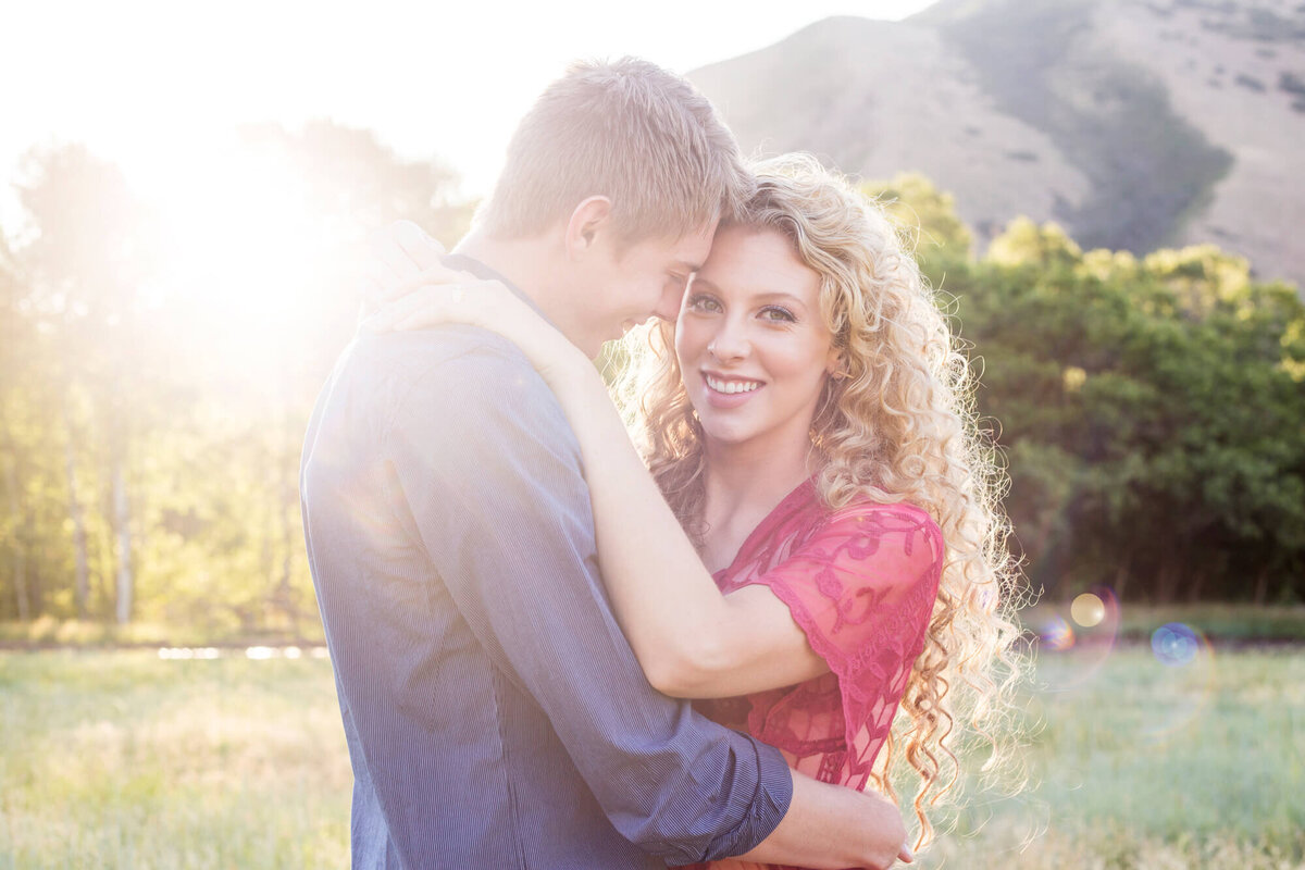 portrait of an engaged couple hugging at sunset in the utah mountains