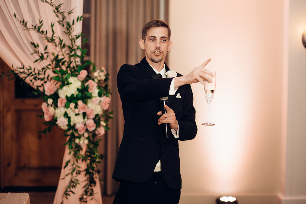 Wedding Photograph Of Groom Speaking In Microphone While Holding a Wine Glass Los Angeles