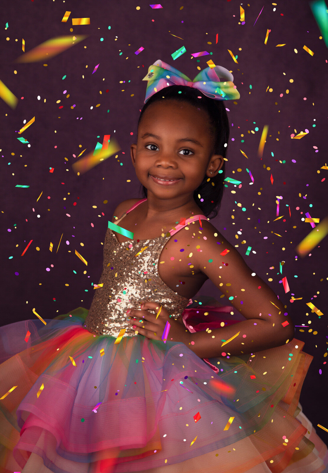 girl-in-rainbow-dress-with-purple-backdrop-and-cofetti