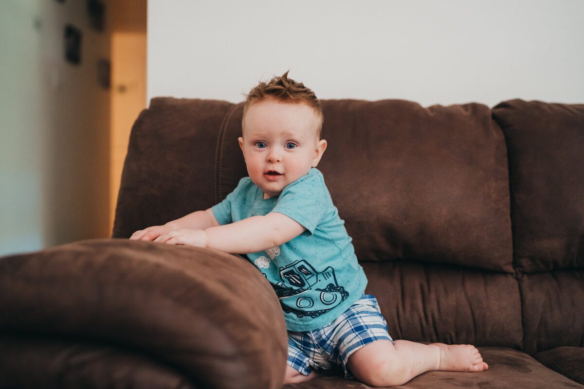 toddler boy sitting on couch