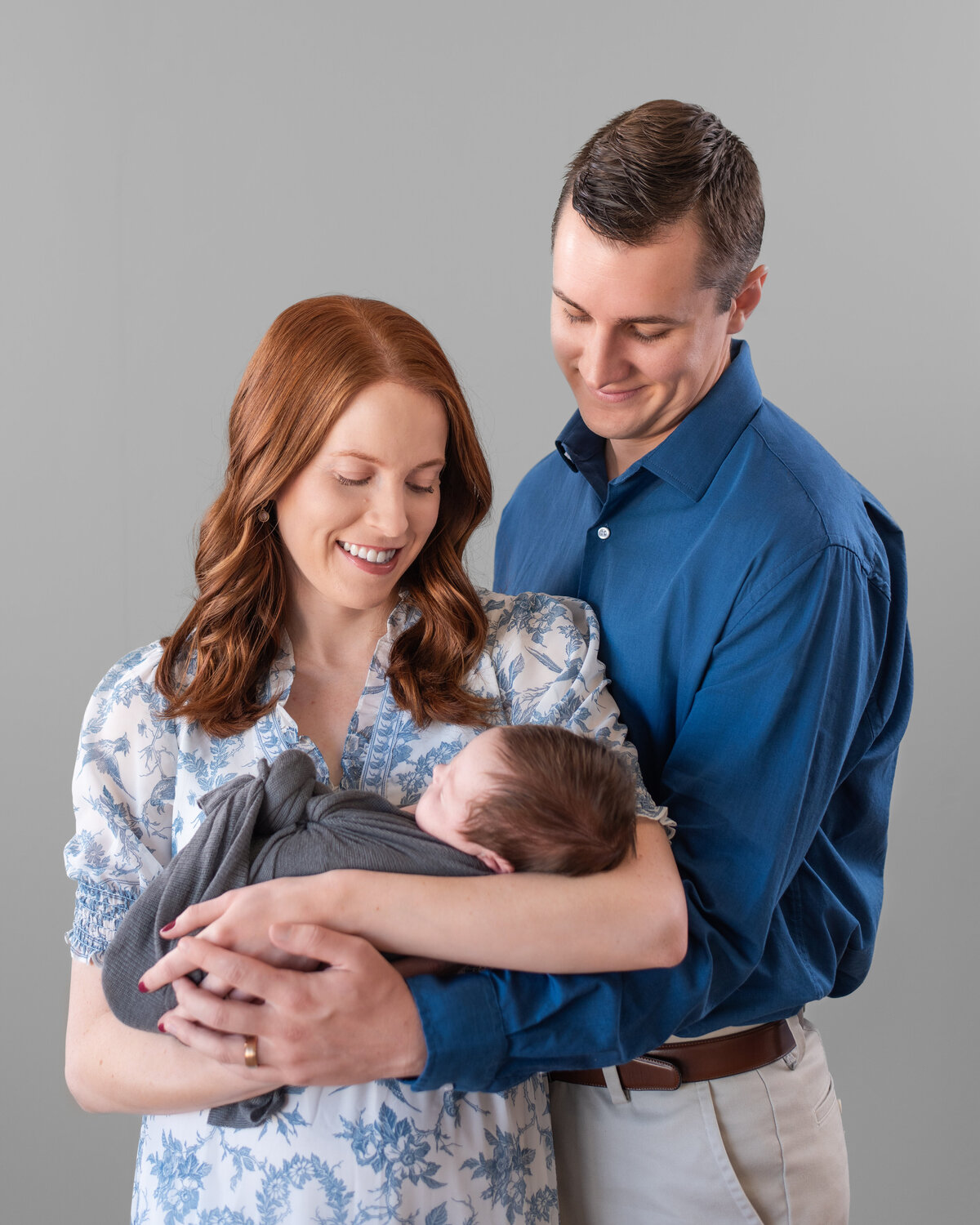 New parents hold their newborn for a high end portrait