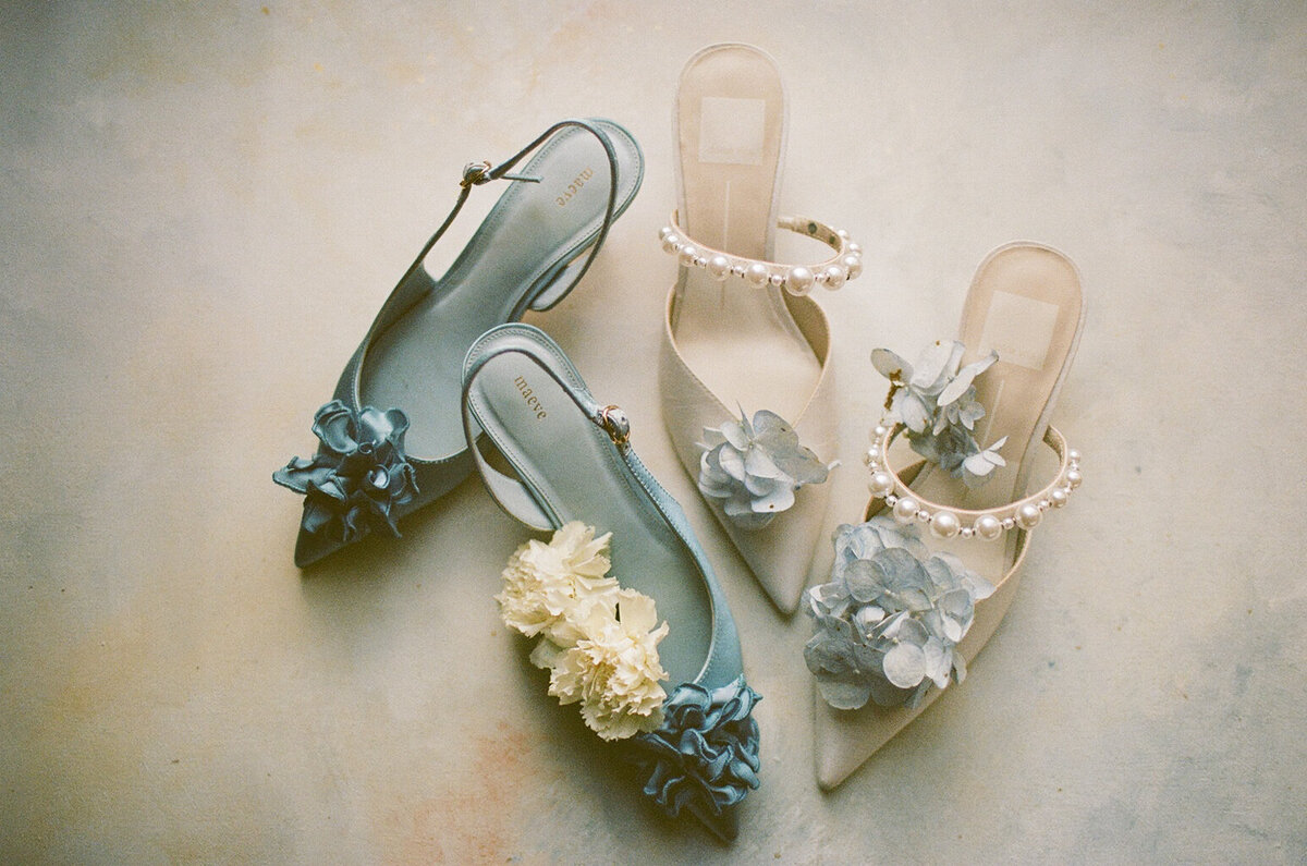 Editorial details of the bride's shoes on 35mm film.