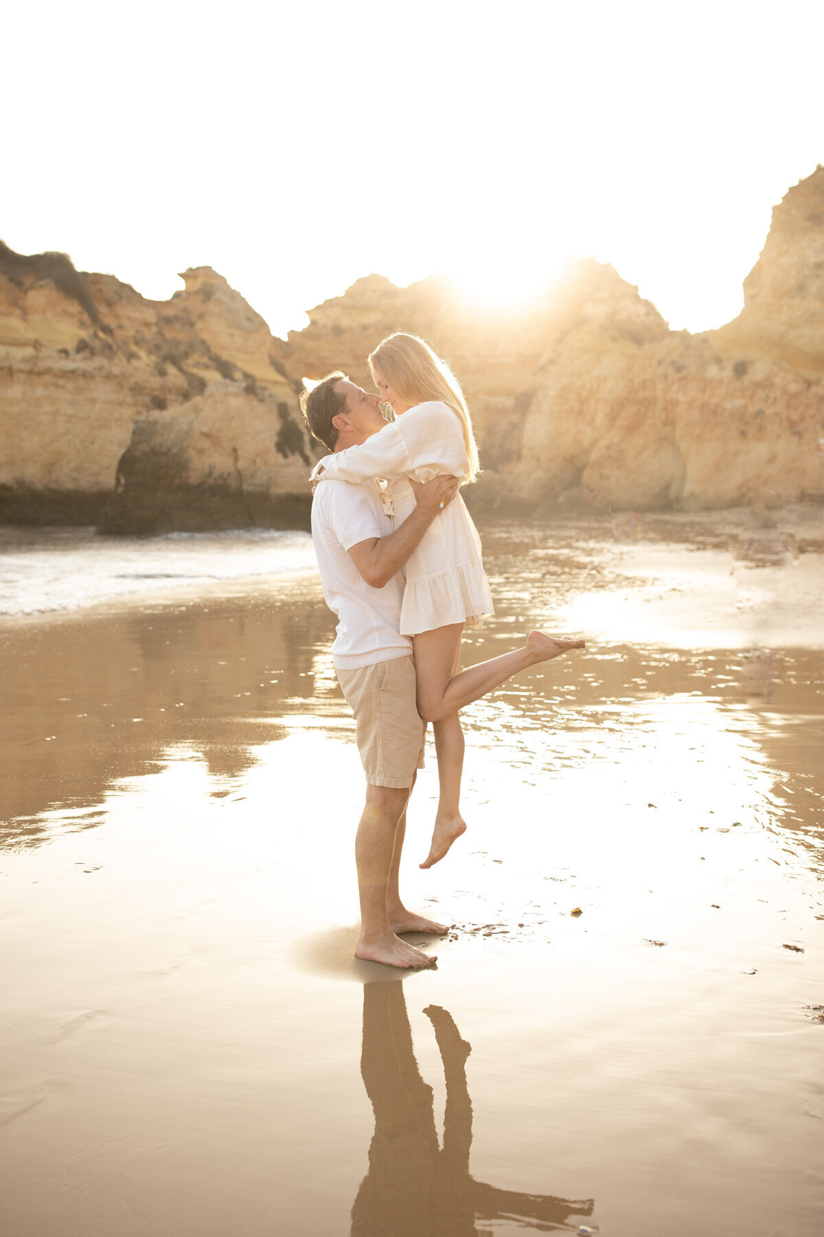 Destination Family Photographer - Portugal - Man lifting woman during a sunset