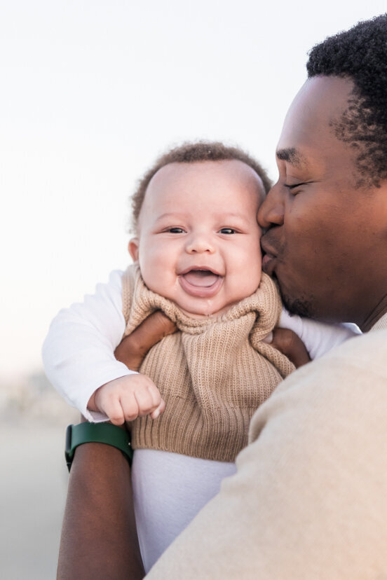 family-portrait-father-kissing-baby-boy