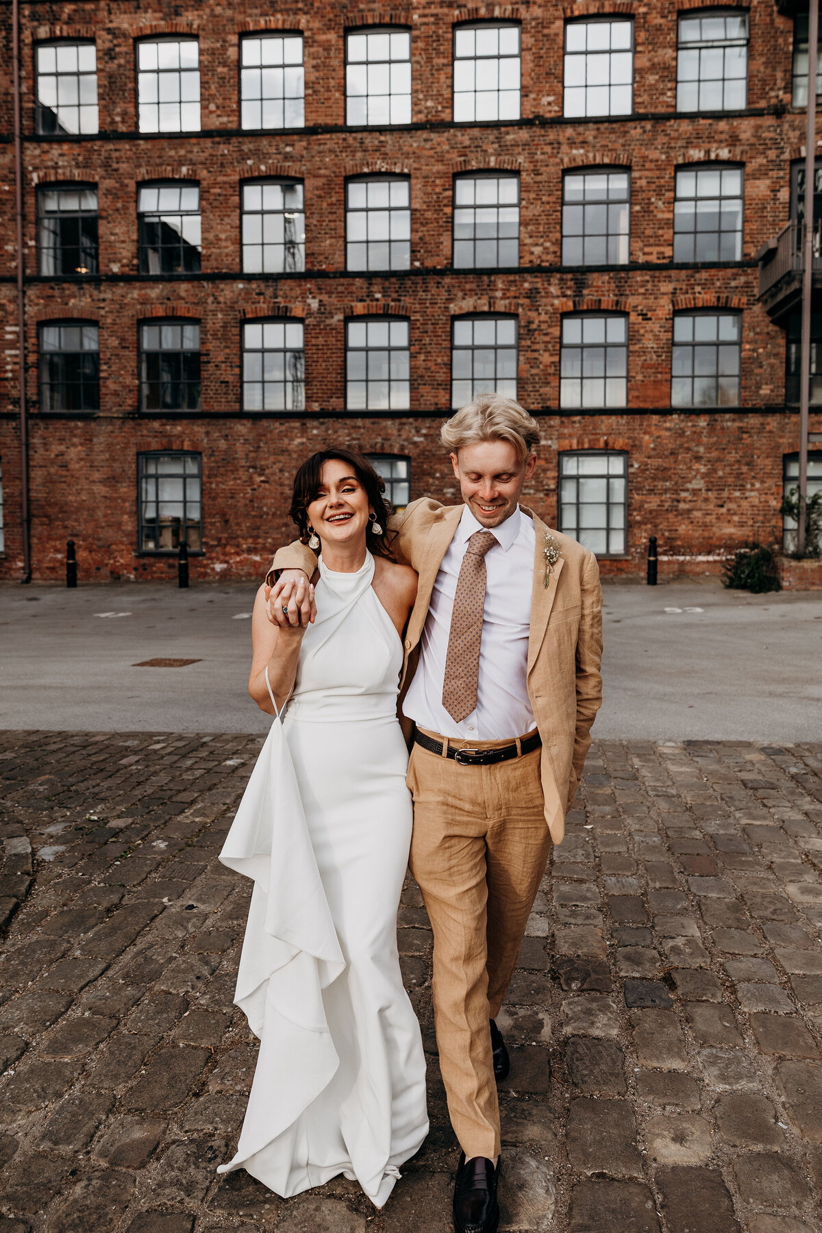 Bride and groom walking outside The Chapter Hall Northern Monk Leeds