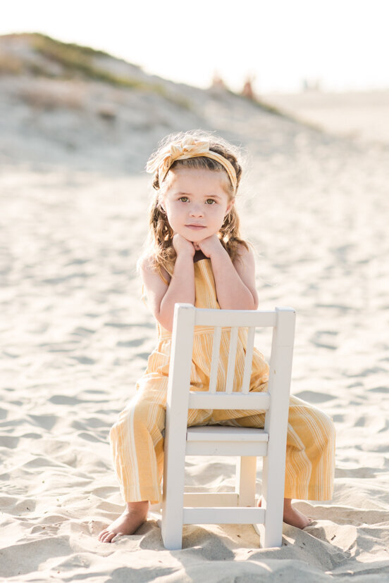 young-girl-sitting-on-chair-in-coronado-sand-dunes-san-diego