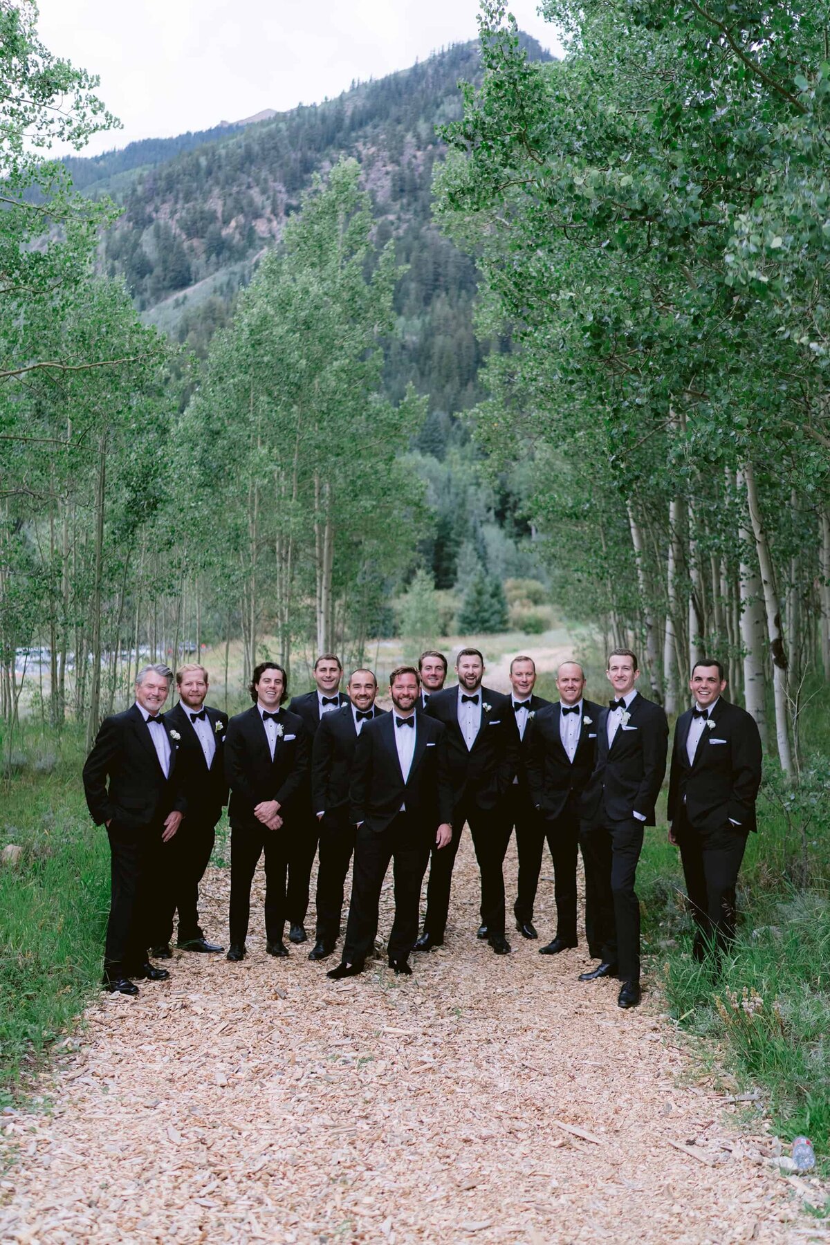Groom and groomsmen in black tuxedos at a custom wedding in Aspen Colorado