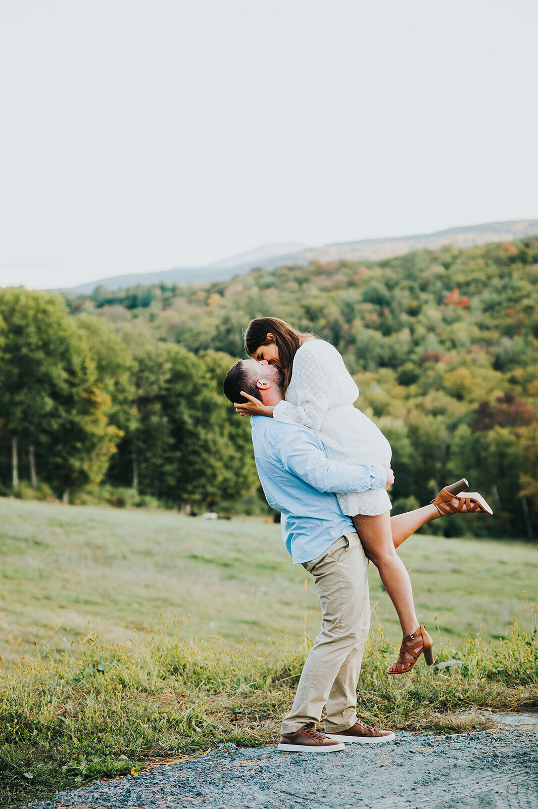 engaged couple kissing in field woodstock vermont