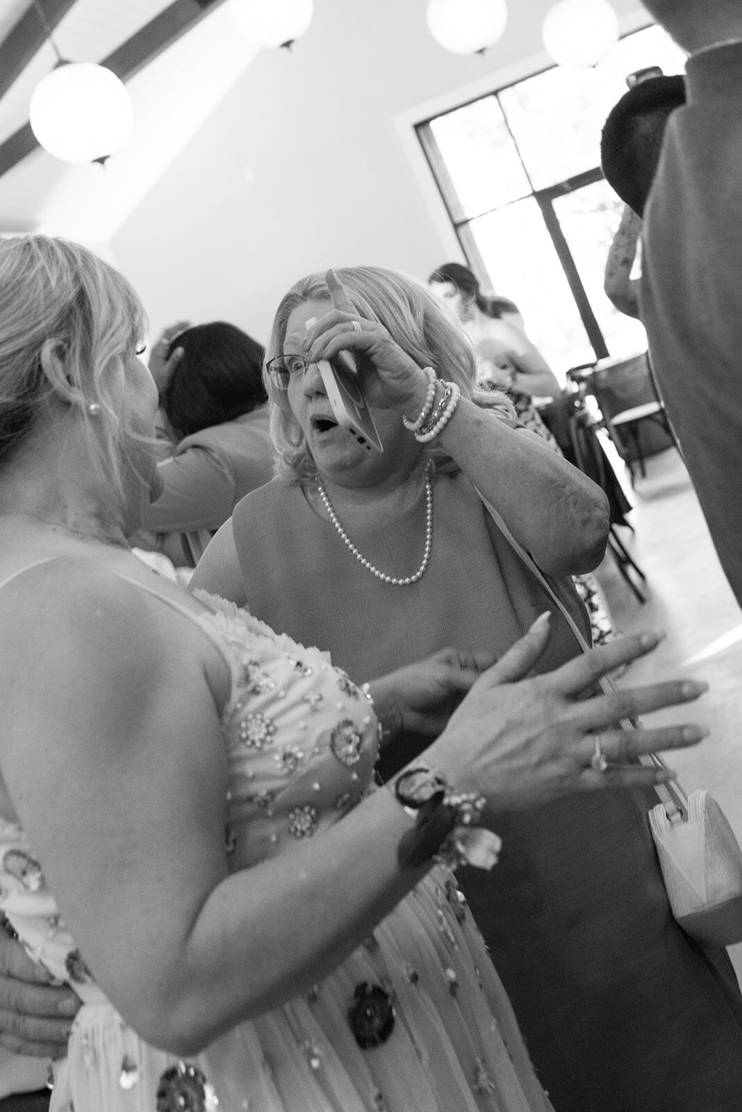 Wedding guests toasting the newlyweds at a Colorado reception, captured candidly on film.