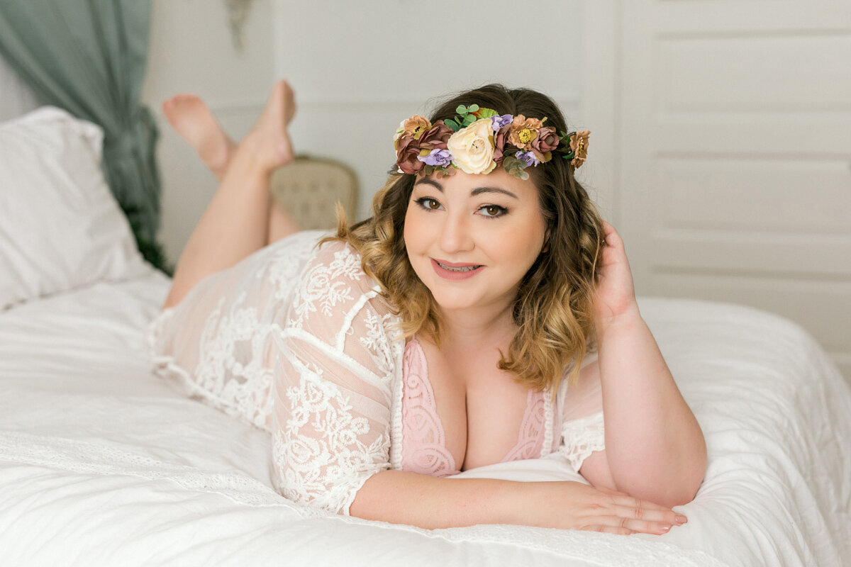 woman in flower crown and lace on bed