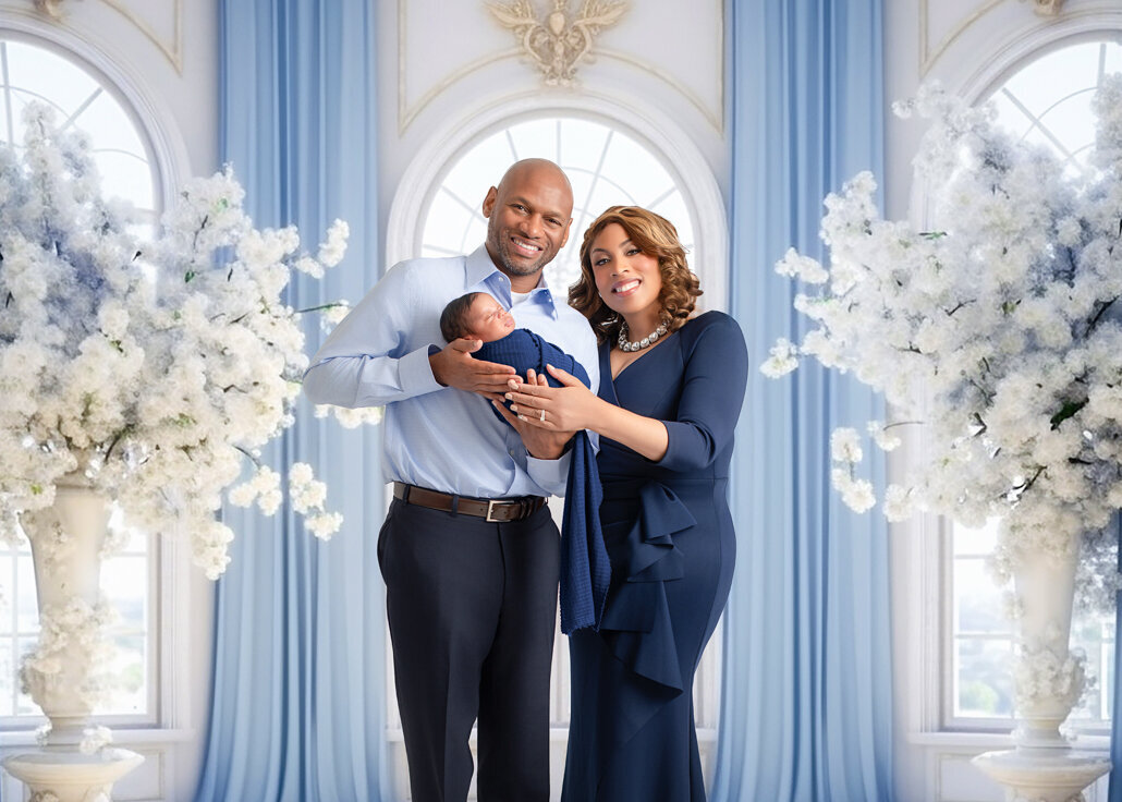 Birmingham newborn photographer captures parents holding their baby boy in elegant studio floral setting