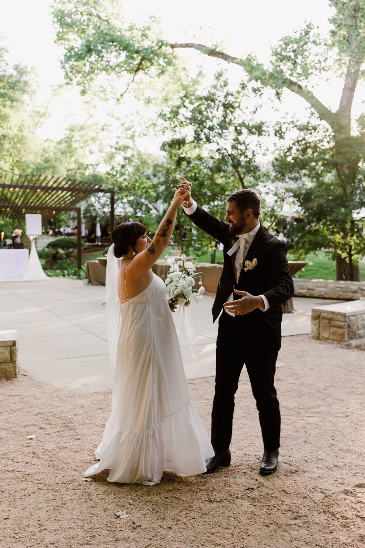 Bride and groom dancing at Umlauf Sculpture Garden, Austin