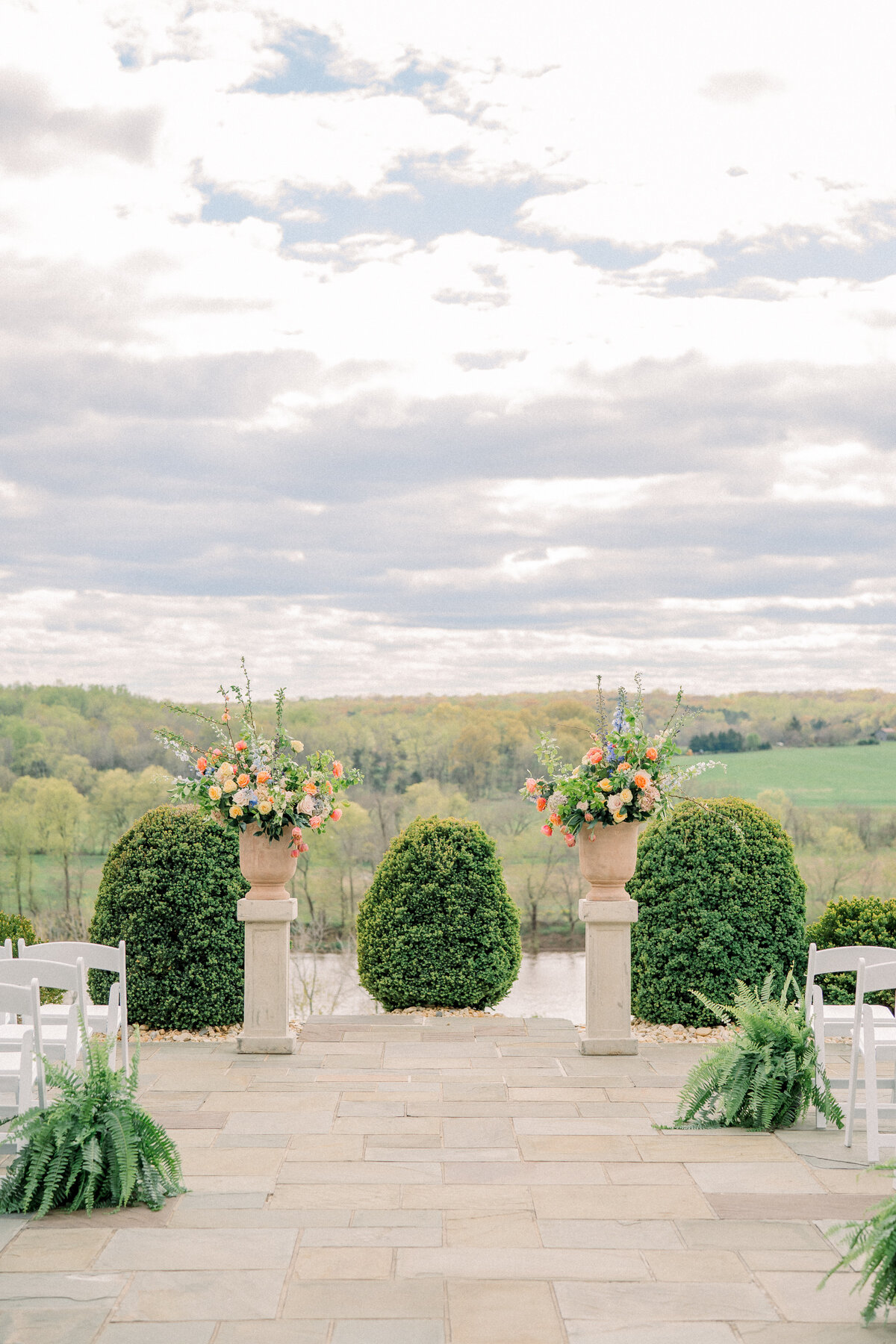 Beautiful ceremony site with florals overlooking an exquisite river and hillside