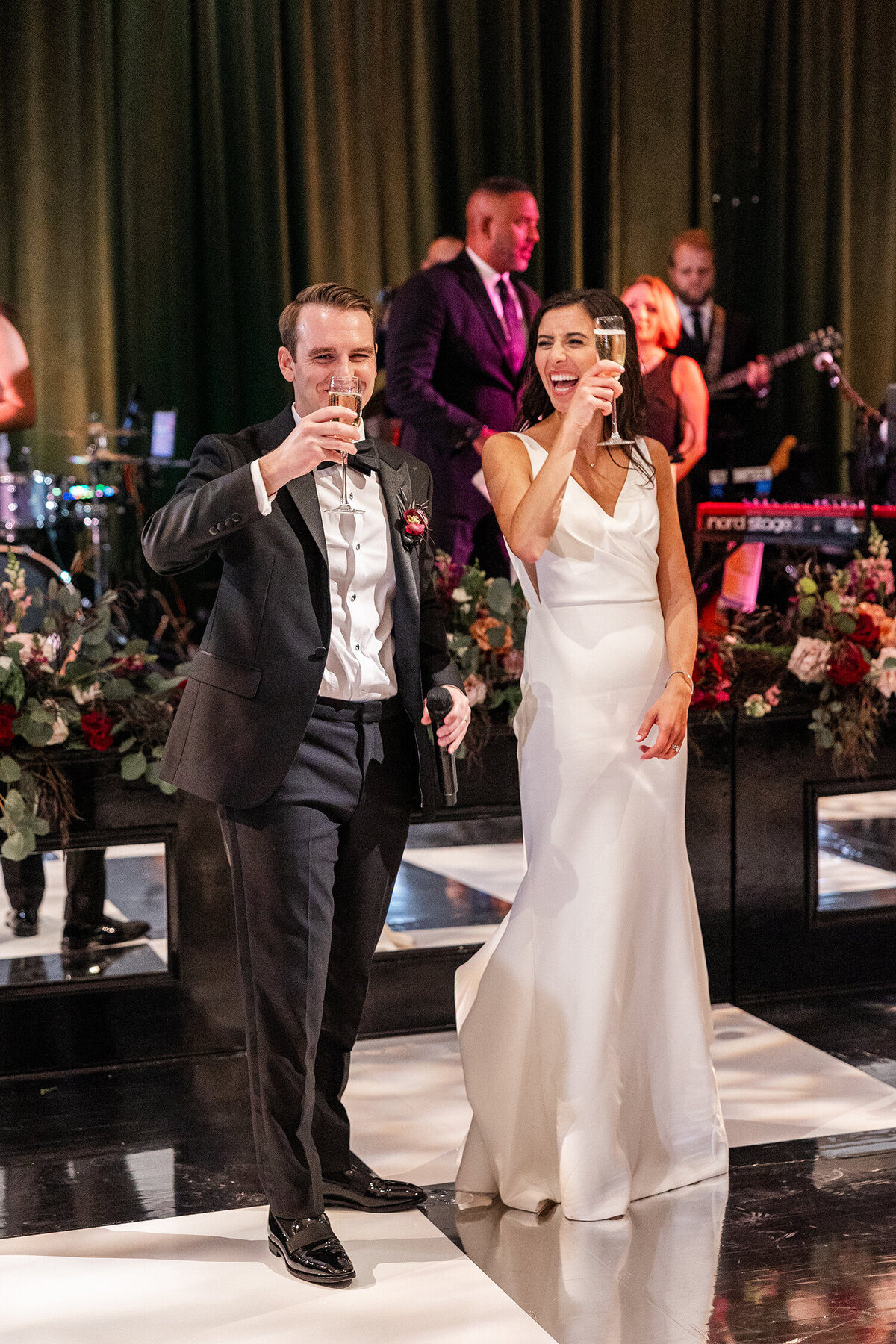 Bride and groom giving a toast at their wedding reception